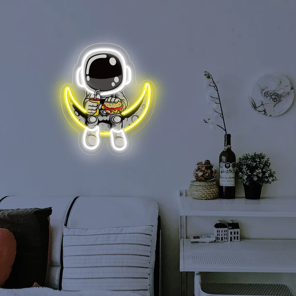 Astronaut on a crescent moon neon sign in a bright living room